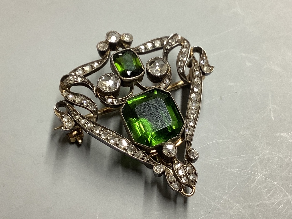 A Victorian gold and silver openwork pendant-cum-brooch set with rose-cut diamonds and emerald cut green paste, H 35mm